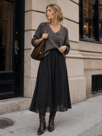 Black pleated midi skirt styled with knit