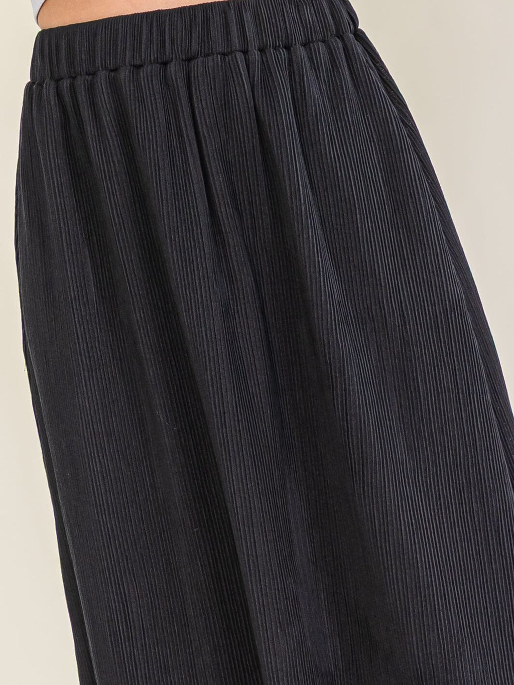 Black pleated midi skirt side