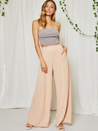 Pleated wide leg trousers in soft taupe on model